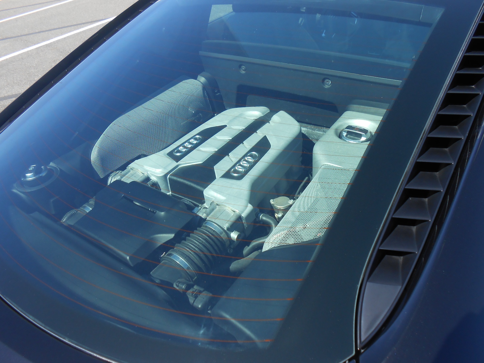 Rear view of a first-gen Audi R8 with the engine visible under the glass cover