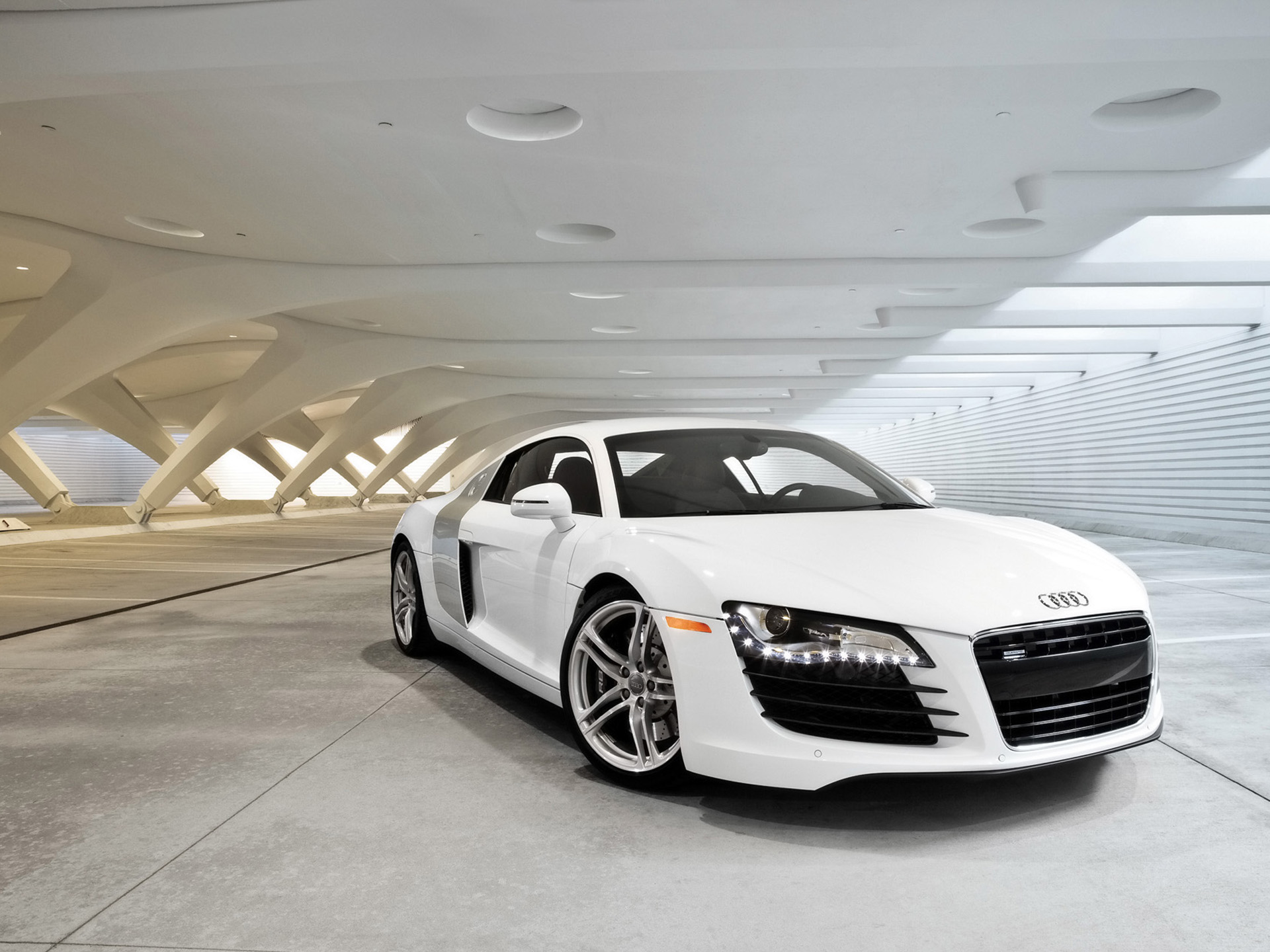 First-gen Audi R8 parked in a modern garage with dramatic lighting, evoking a cinematic Tony Stark vibe