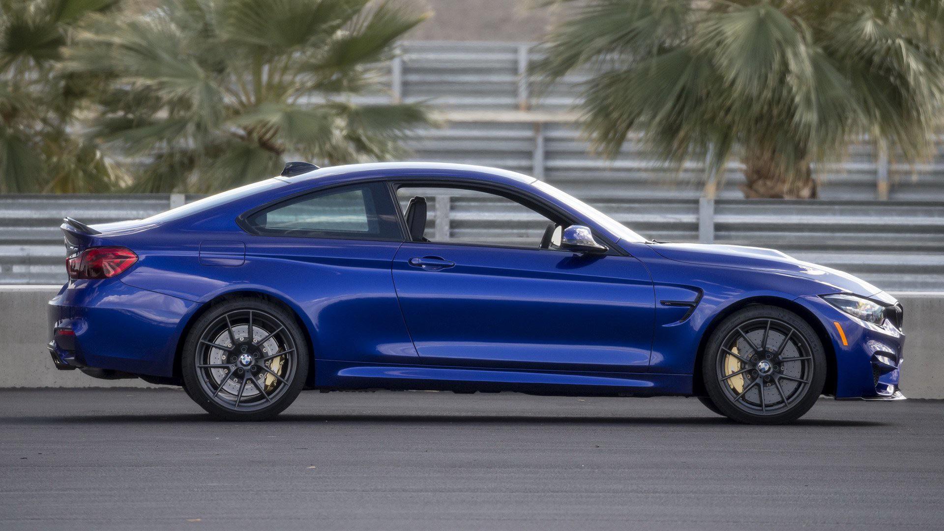 Side profile detail of a BMW M4 F82 highlighting the fender vent (M gill) and sculpted M mirror