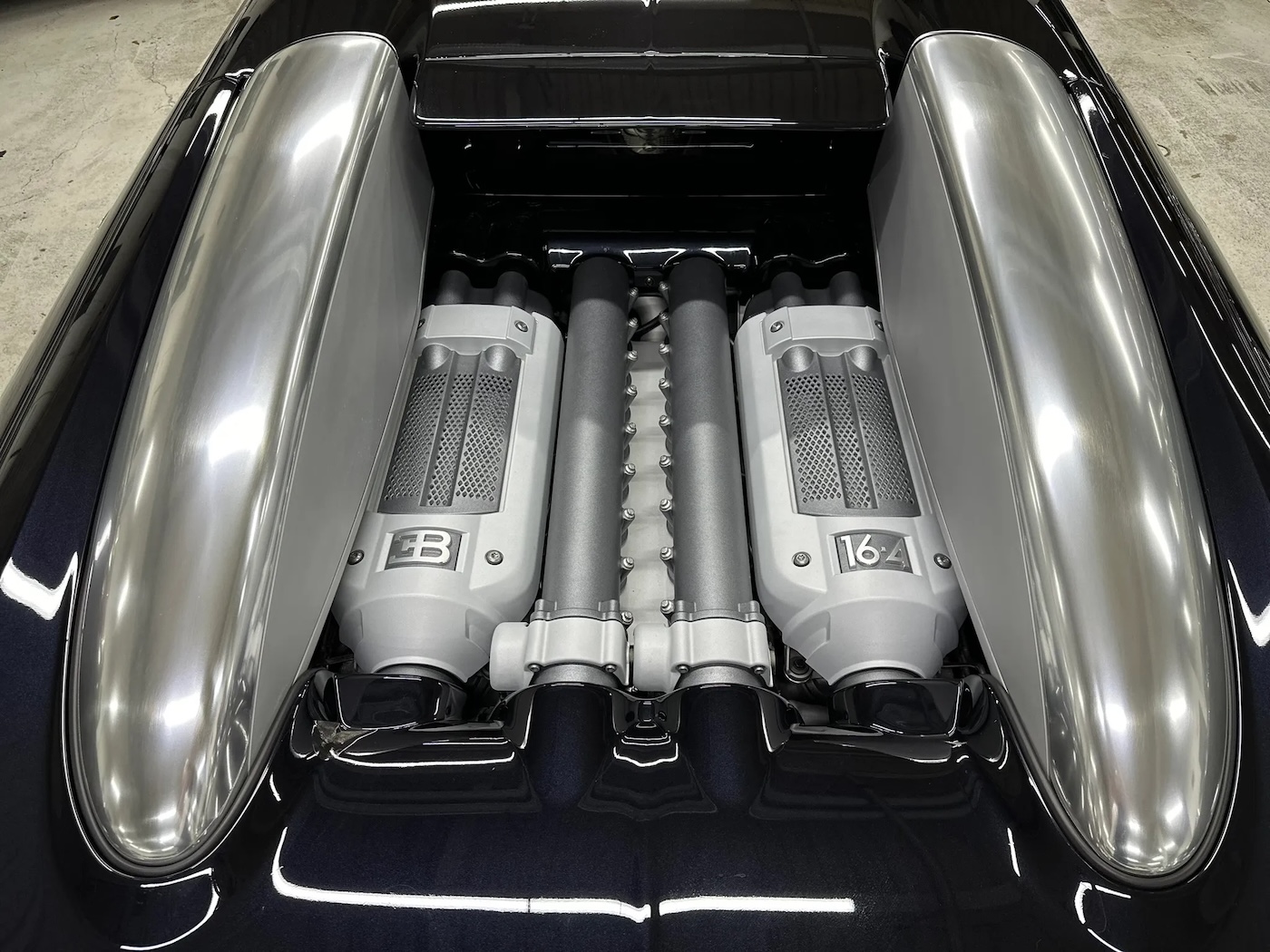 Close-up of the Bugatti Veyron W16 engine bay and visible intake plumbing