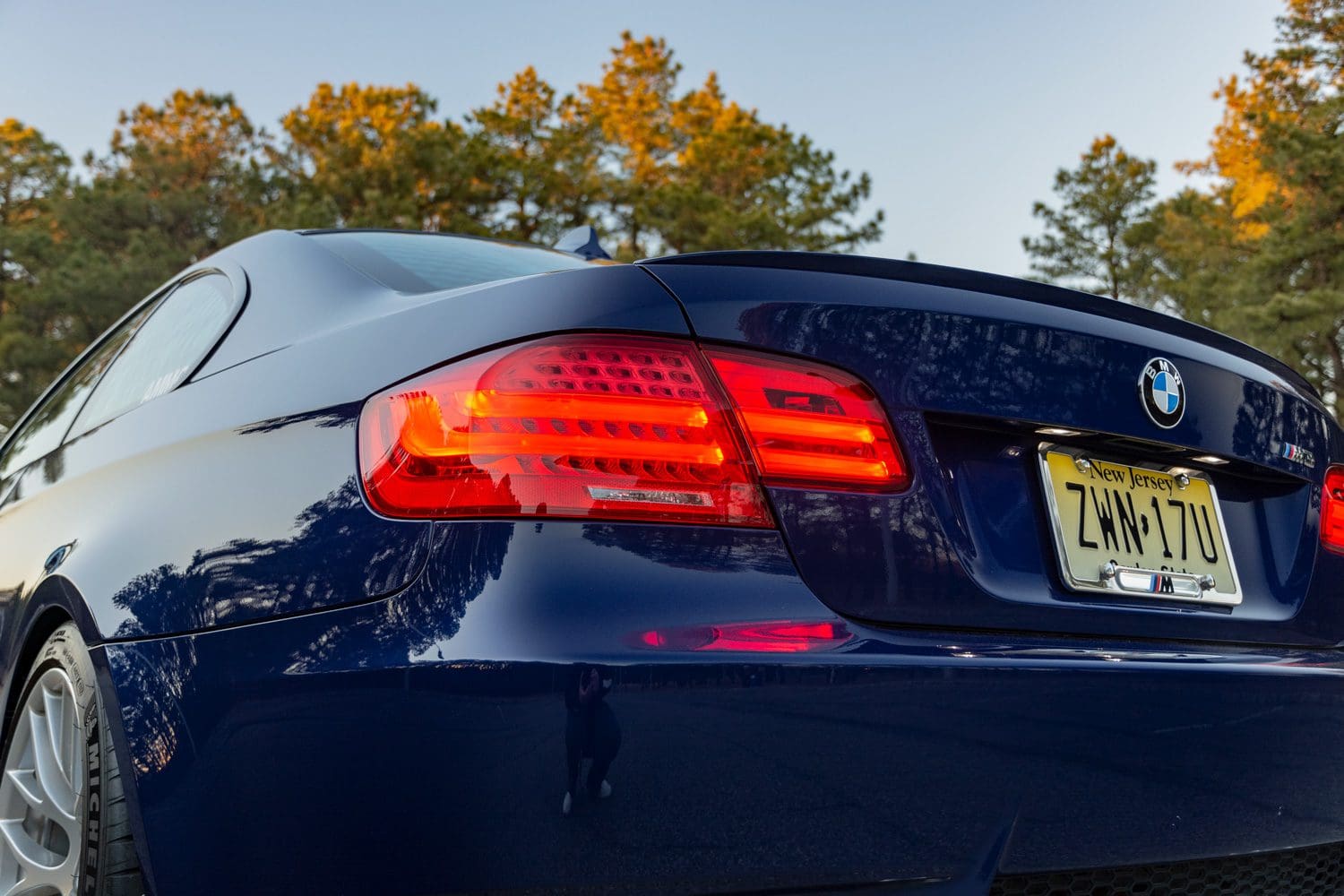 Close-up comparison-style photo of E92 rear taillights showing the updated LED light signature on a facelift (LCI) model