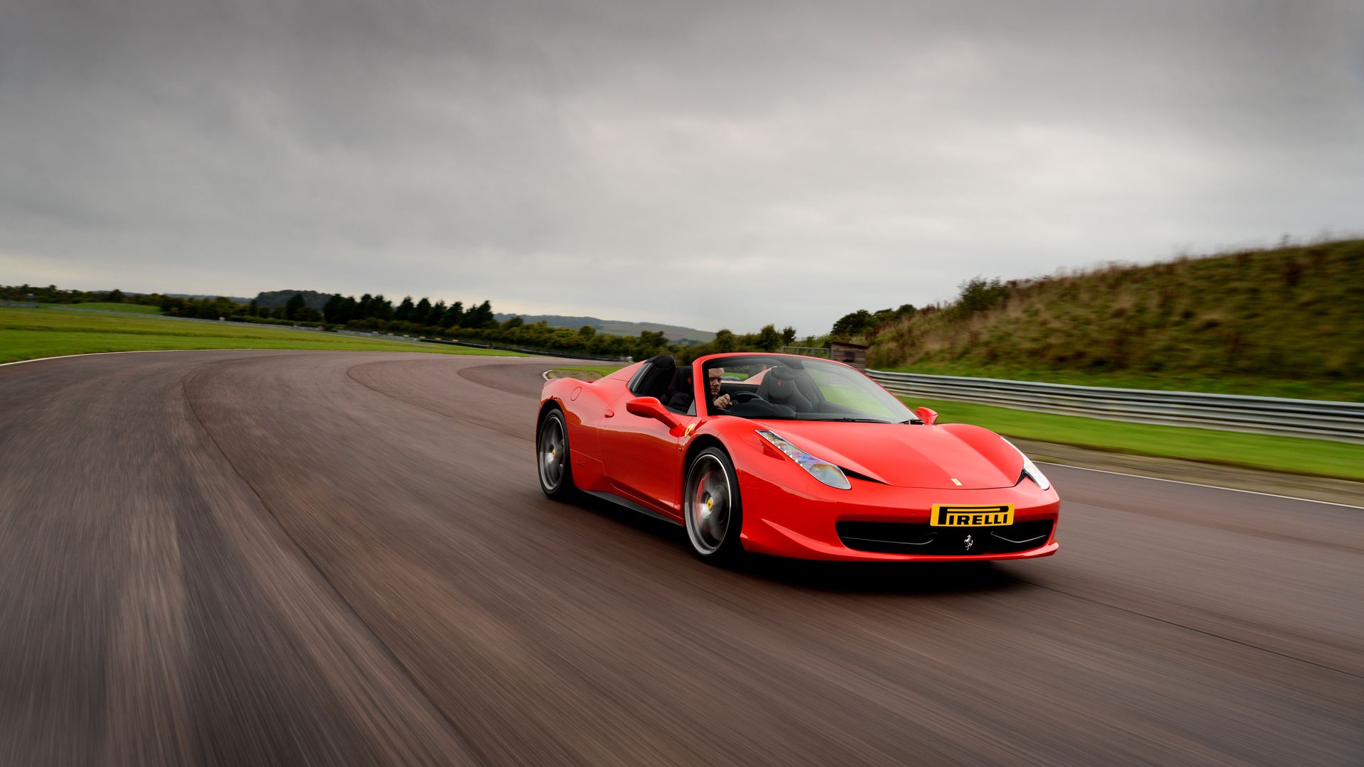 Ferrari 458 Italia cornering on track with visible body roll control and aggressive stance