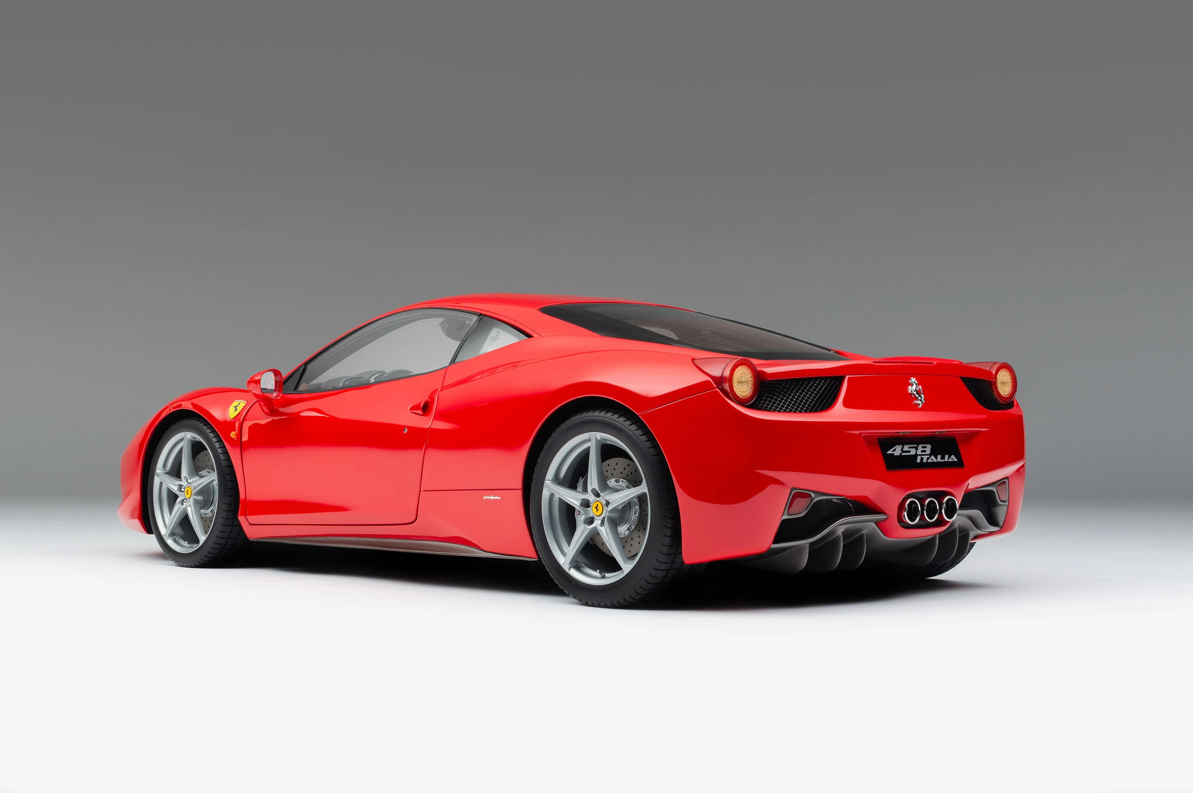 Close-up rear shot of a Ferrari 458 Italia showing the center triple exhaust and rear diffuser