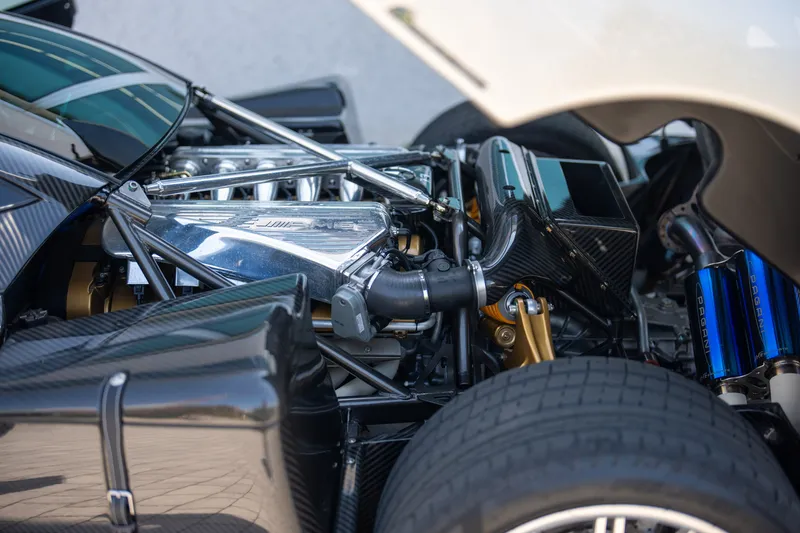 Engine bay of a Pagani Zonda showing the AMG-derived V12 and carbon fiber surrounding structure