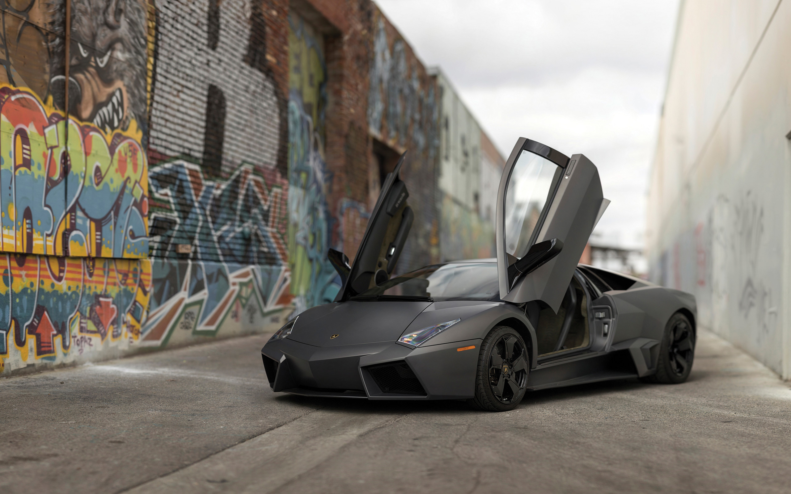 3/4 front shot of a Lamborghini Reventón in its signature matte/gray finish, showing the angular, aircraft-inspired bodywork
